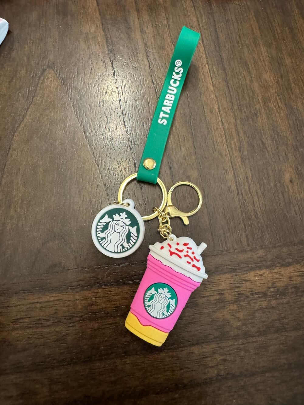 Starbucks pink drink cup keychain with white whipped cream and red sprinkles